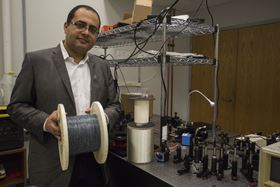 Ayman Abouraddy with a roll of multi-layered fiber. Photo: UCF.