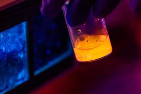 A vial of fluorescing boron nitride nanotubes. Image: Jeff Fitlow/Rice University.